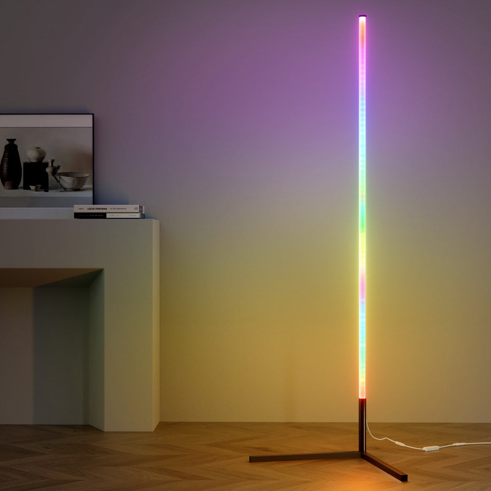 RGB bar floor lamp with rainbow gradient casting purple and yellow glow on wall, styled next to white console table