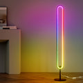 RGB oval floor lamp with rainbow spectrum glow in room, purple wall above and yellow below, white console table alongside