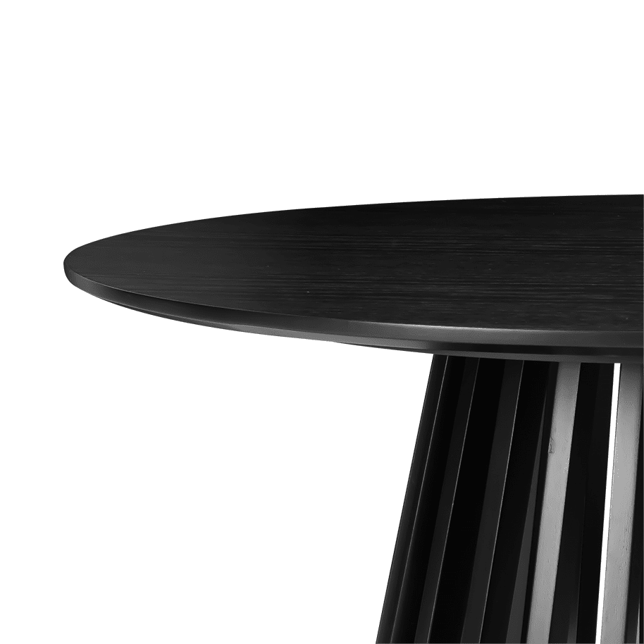 Close-up of the edge and slatted base junction of a black round coffee table showing the rounded tabletop profile and