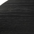 Close-up of a black round coffee table surface showing fine horizontal wood grain texture across the tabletop