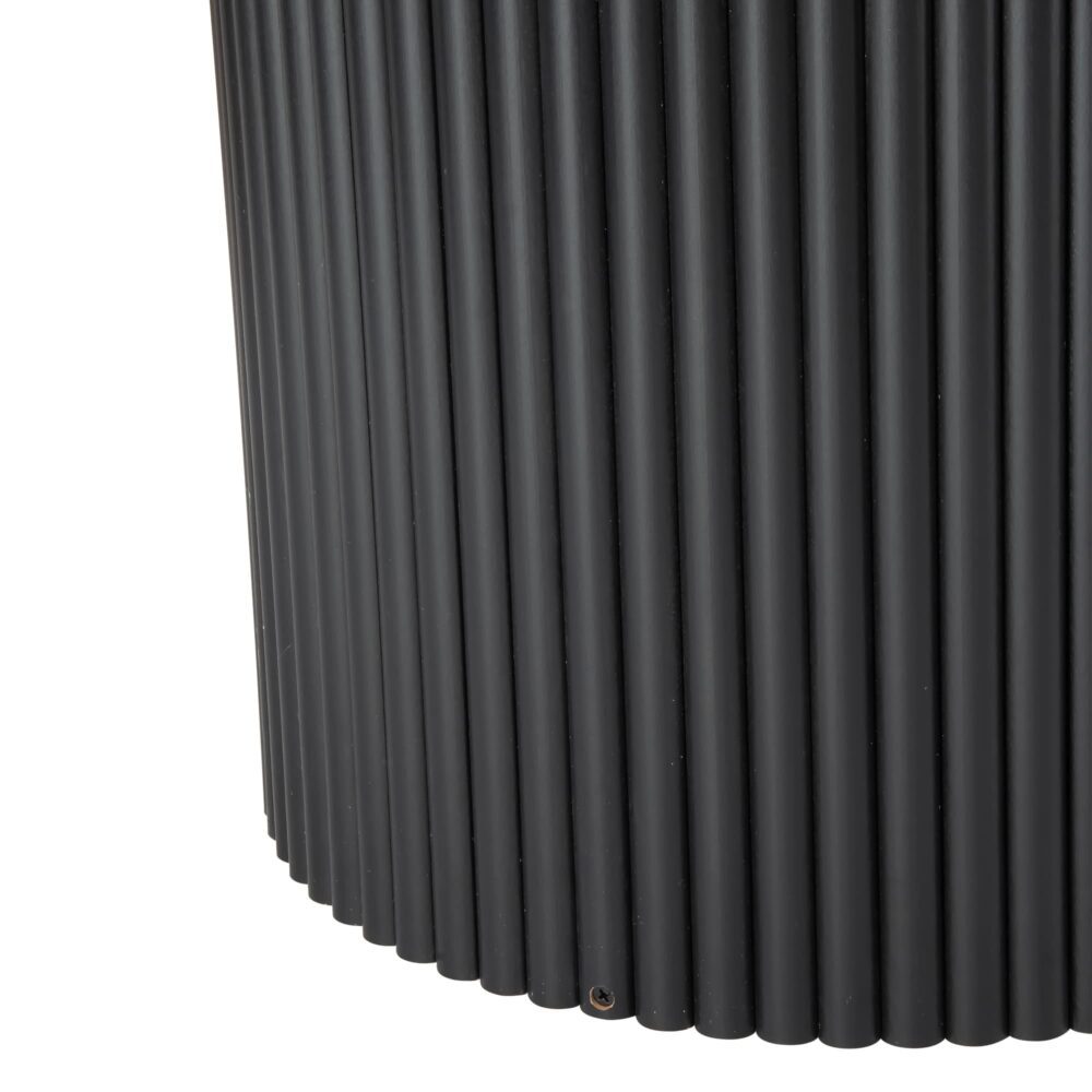 Close-up of black fluted cylindrical pedestal base of round coffee table showing ribbed tube detail