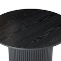 Close-up top-angle of black round coffee table showing full wood grain texture of round top with fluted pedestal below