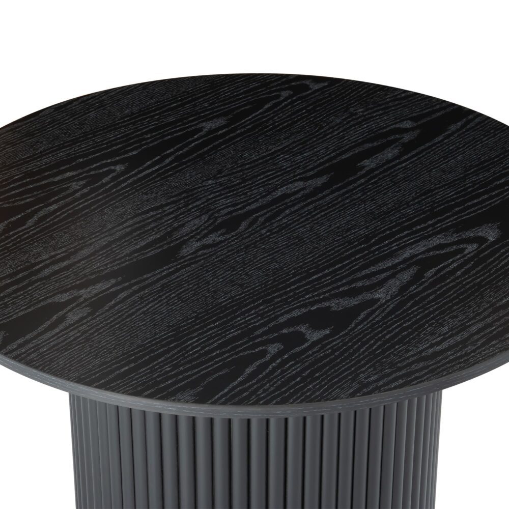 Close-up top-angle of black round coffee table showing full wood grain texture of round top with fluted pedestal below