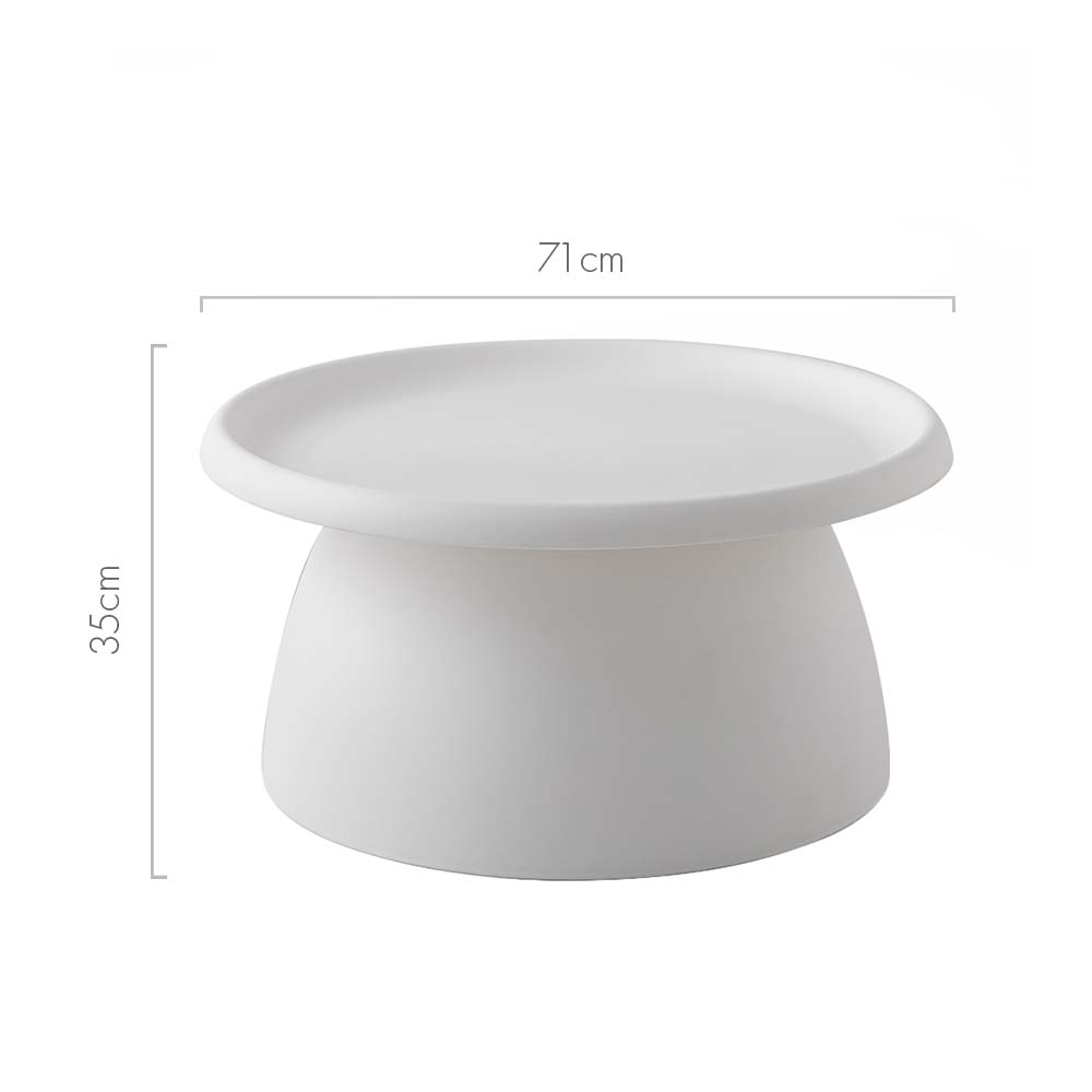 Round white coffee table with wide tray top and tapered cylindrical base in a living room with a bouclé sofa and timber floor