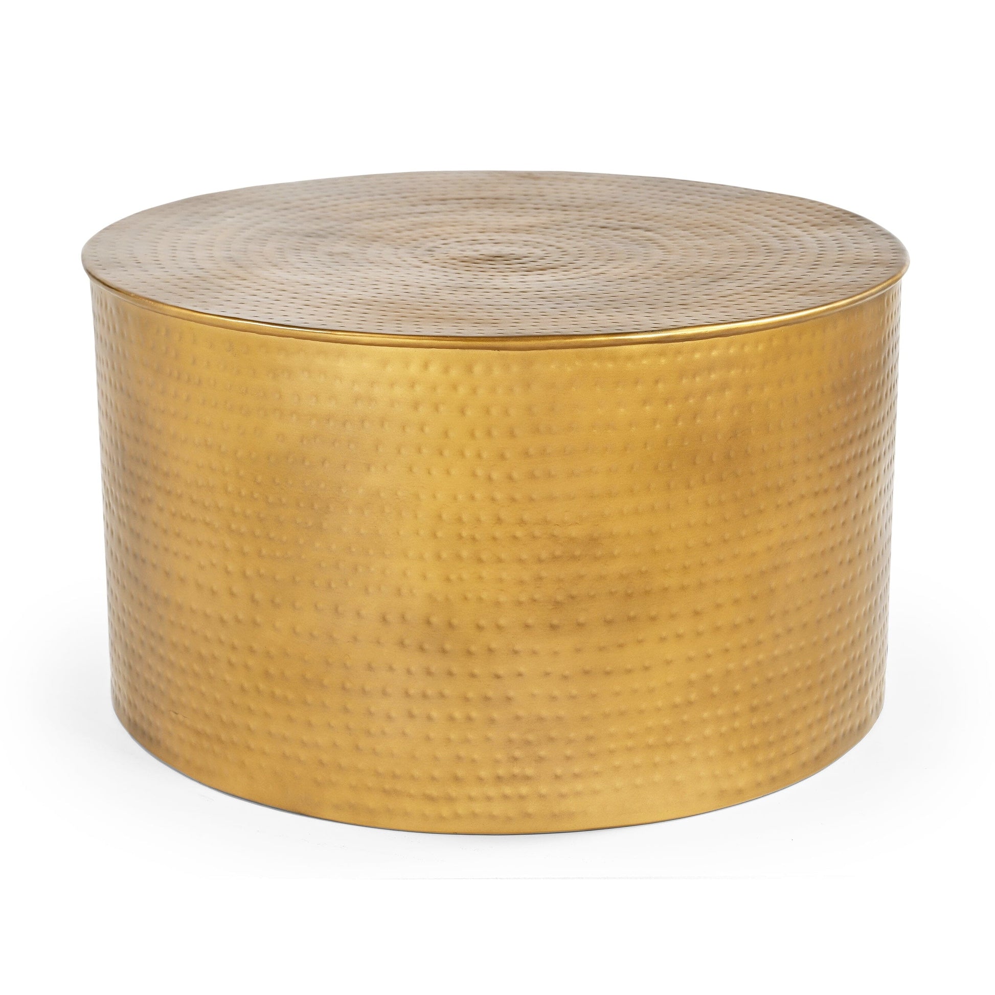 Close-up of the top edge of a cylindrical hammered brass-finish metal coffee table showing concentric dimple texture and