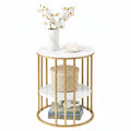 Round marble top side table with gold frame, orchids and cake on top, rattan basket on mid shelf, books on bottom