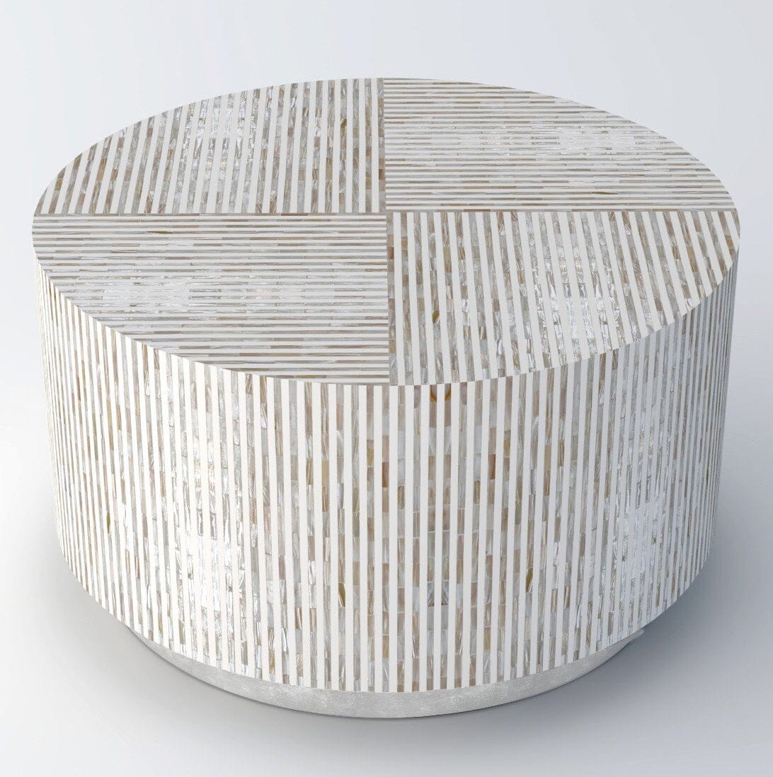 Round drum coffee table with vertical mother of pearl mosaic tile cladding and four-quadrant patterned top photographed from