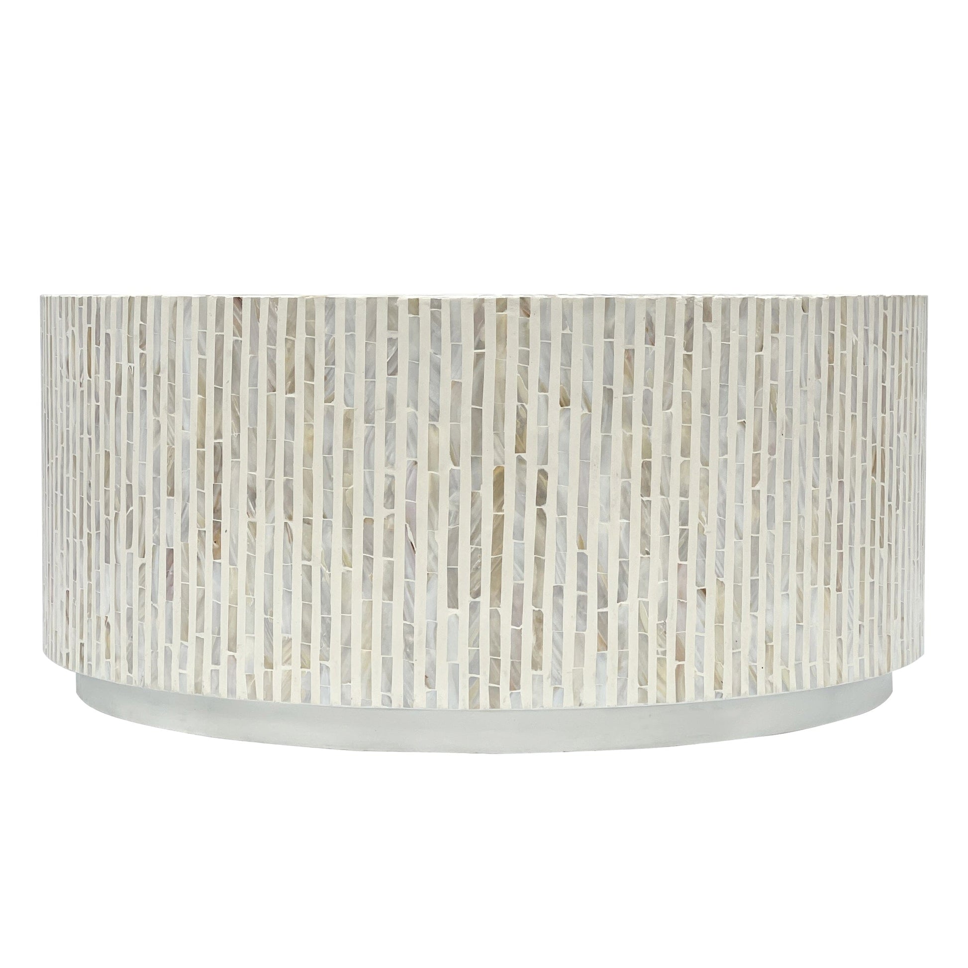 Top-down view of round coffee table surface covered in mother of pearl mosaic tiles arranged in four alternating direction