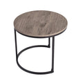 Small round nesting coffee table with grey-tone wood grain top and black C-shaped metal base on white background
