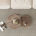 Top-down view of two round nesting coffee tables with walnut wood grain tops on grey carpet near sofa