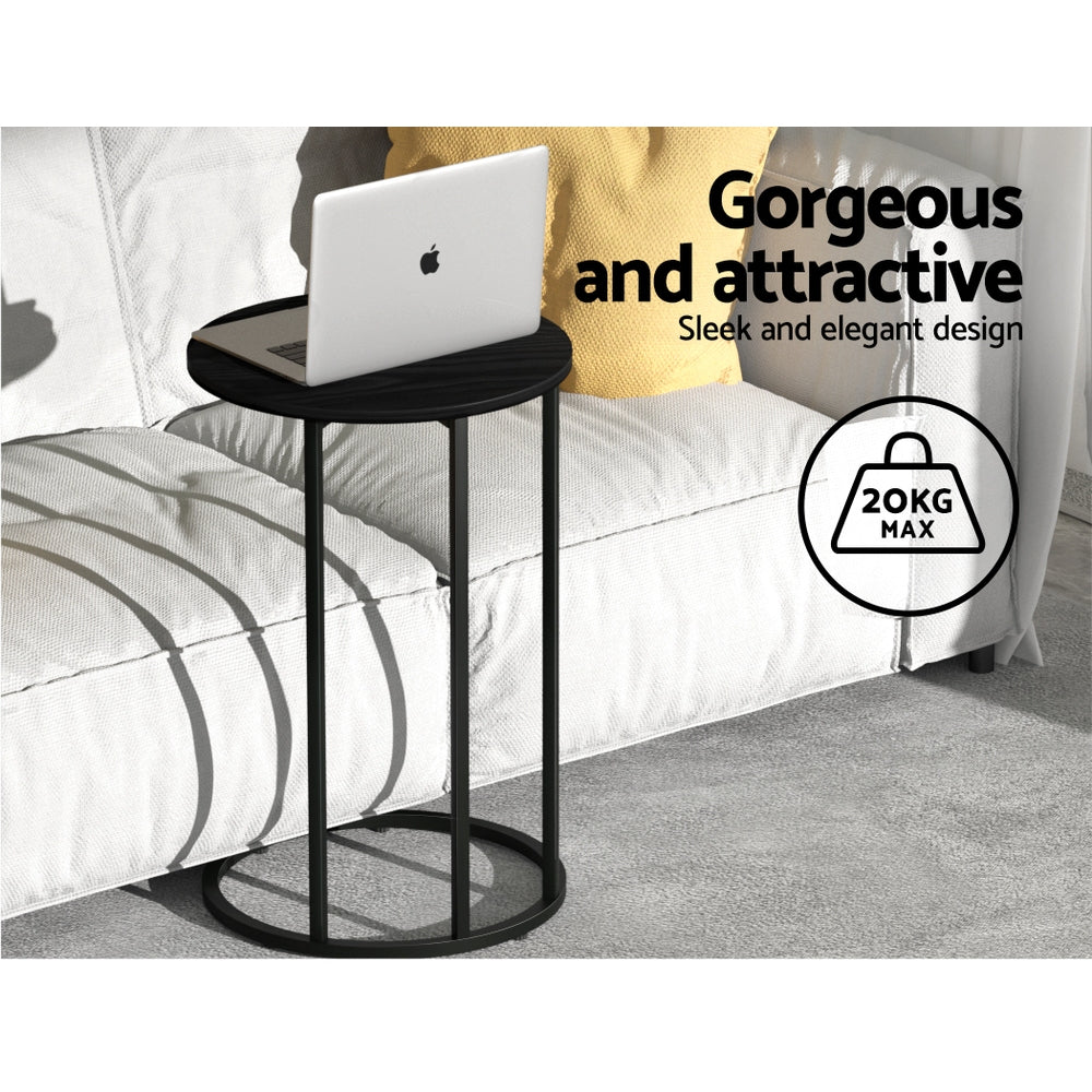 Round black side table beside sofa with laptop on top, text: 20kg max weight capacity, sleek and elegant design