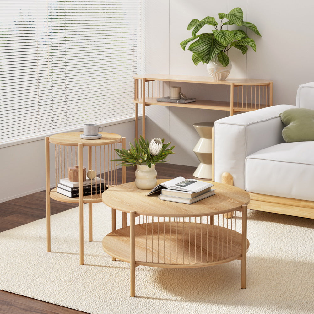 Natural oak round coffee table, side table and console table set styled in a living room with a white sofa and indoor plants