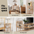Round two-tier natural wood side table shown in four room settings including bedroom, living room, break room and meeting