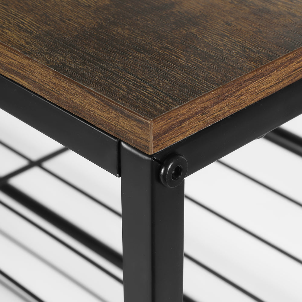Close-up of rustic brown wood top corner meeting black metal frame on 4-tier industrial shoe rack