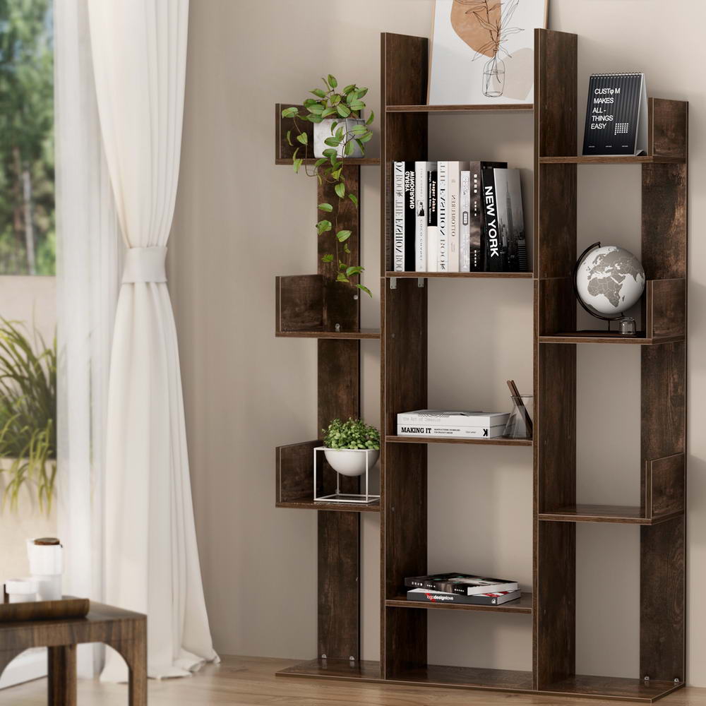 Dark brown asymmetric tree-style bookcase with staggered shelves, styled with books and plants in a bright living room