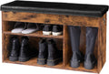 Rustic wood finish shoe bench with black PU leather cushion top and three open compartments loaded with boots