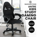 Sarantino Antre all-black kids study gaming chair in room with white desk, ergonomic back rest and padded armrests badges