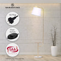Sarantino arc floor lamp with side table lit in concrete room with callouts for AU Plug, Floor Switch, and SAA Approvals