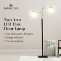 Sarantino Two Arm LED Task Floor Lamp lit in beige room: two adjustable LED lights, energy efficient, two tone design