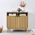 Sarantino Eleni sideboard in room setting, router and books in open niches, vases and foliage on top, wicker baskets on floor
