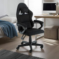 Sarantino all-black kids gaming chair in bedroom next to timber desk with computer monitor, rug and storage cube