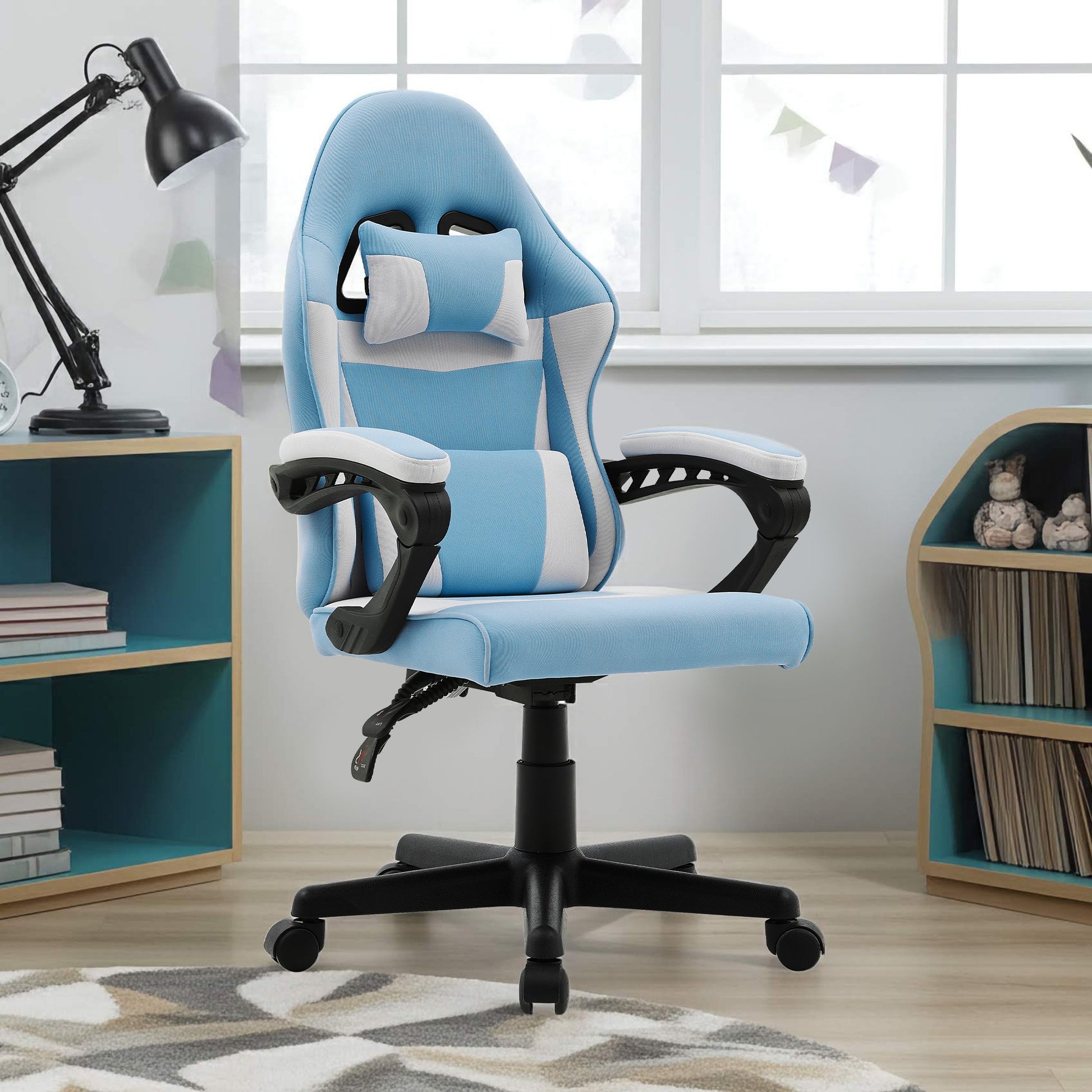 Sarantino light blue kids gaming chair in children's bedroom next to bookshelf and lamp with patterned rug on floor
