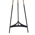 Close-up of matte black tripod base showing three slim legs with curved triangular crossbrace, gold brass gradient legs above