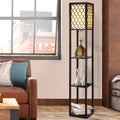 Black lattice shelf floor lamp in living room with leather sofa, three shelves holding decorative bottle and white vases