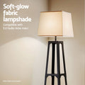 Close-up of tapered black shelf floor lamp with beige fabric shade glowing, text overlay E27 60w max compatible