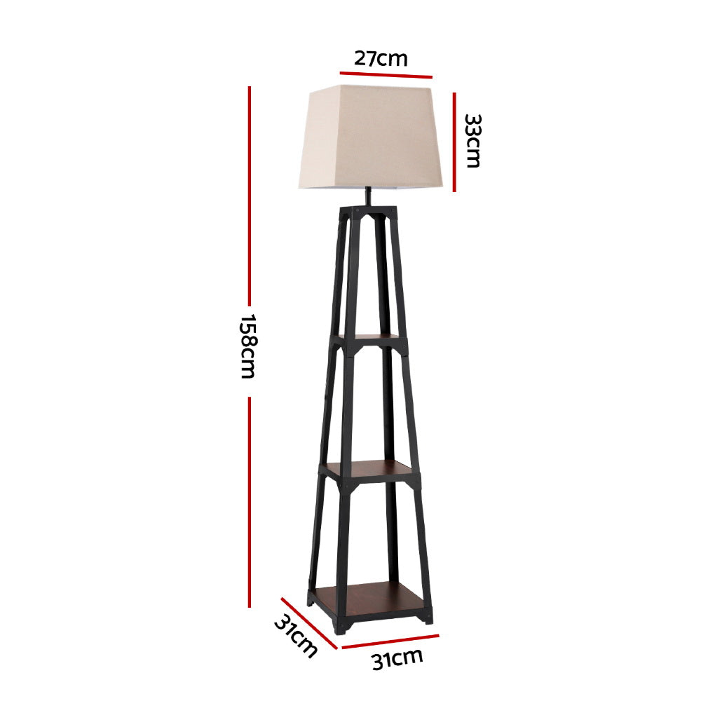 Tapered black shelf floor lamp with beige square fabric shade and two open empty shelves on white background