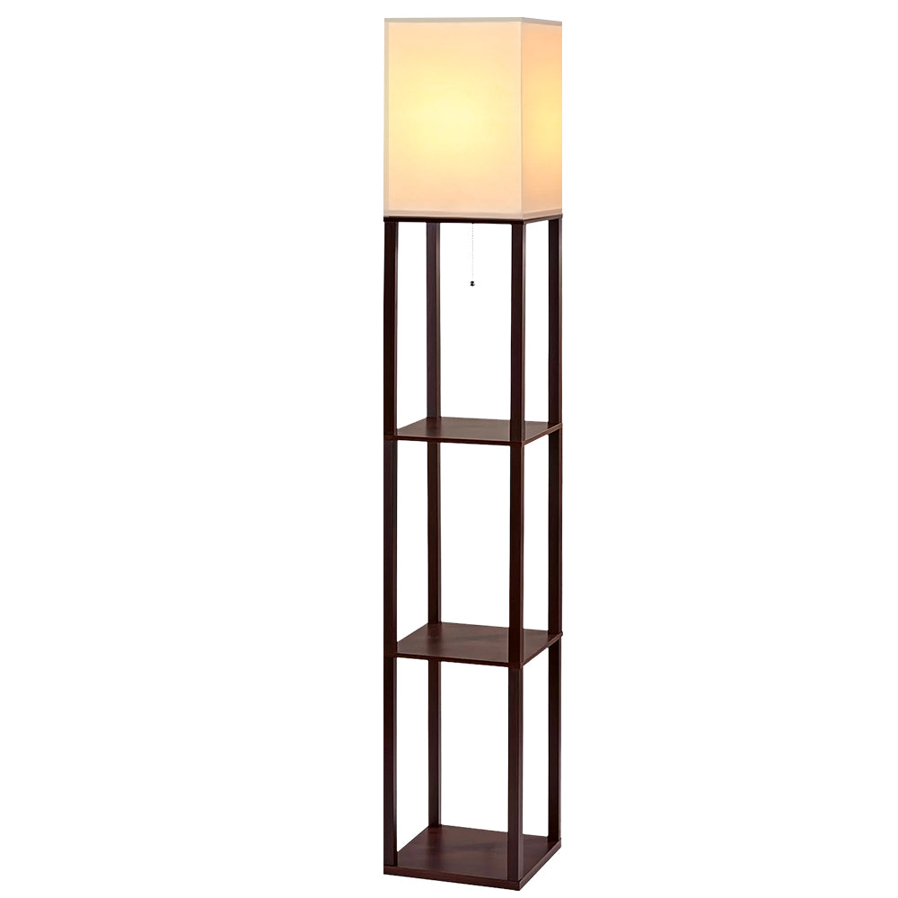 Walnut shelf floor lamp with lit white square shade, two open shelves, and pull-chain switch on white background