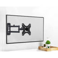 Small full-motion TV wall bracket lifestyle with TV on white wall plants in wood tray and glass dome at corner
