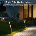 Angled solar path lights glowing on stone garden path beside modern house, Bright Solar Garden Lights text at top