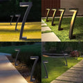 Four outdoor lifestyle scenes of angled solar path lights in grass, stone garden paths, patio and lawn settings at night