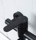 Black stainless steel basin faucet detail showing water outlet and mechanism