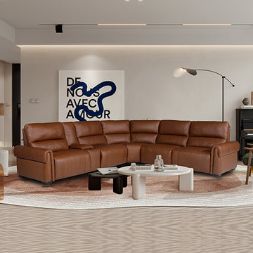 Tan leather L-shaped recliner sectional in warm modern living room with round white coffee table