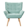 Teal green grid-tufted fabric armchair with winged back and natural wood tapered legs, front view on white background