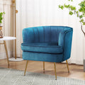 Teal velvet tub armchair with channel-stitched curved back and gold metal legs in lifestyle room with sheer curtains