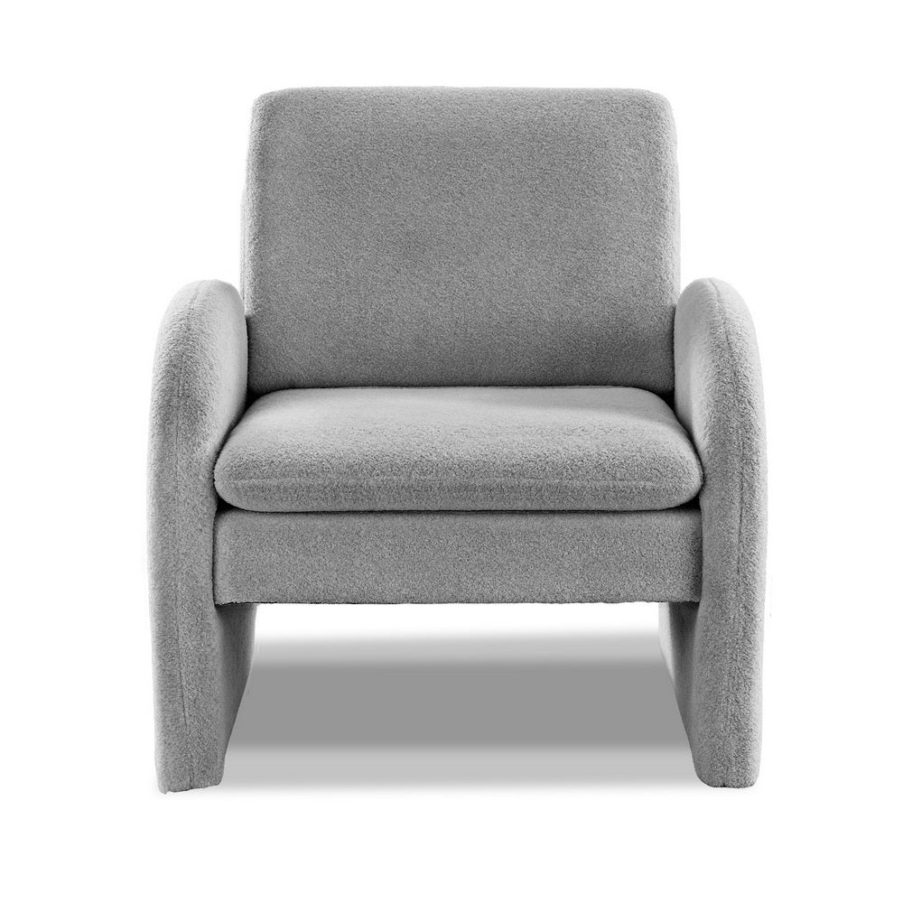 Grey boucle arch-panel armchair with cushioned seat, front view on white background