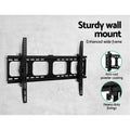 Tilting TV wall bracket sturdy wide frame on grey wall with anti-rust powder coating and heavy-duty fixings close-up circles