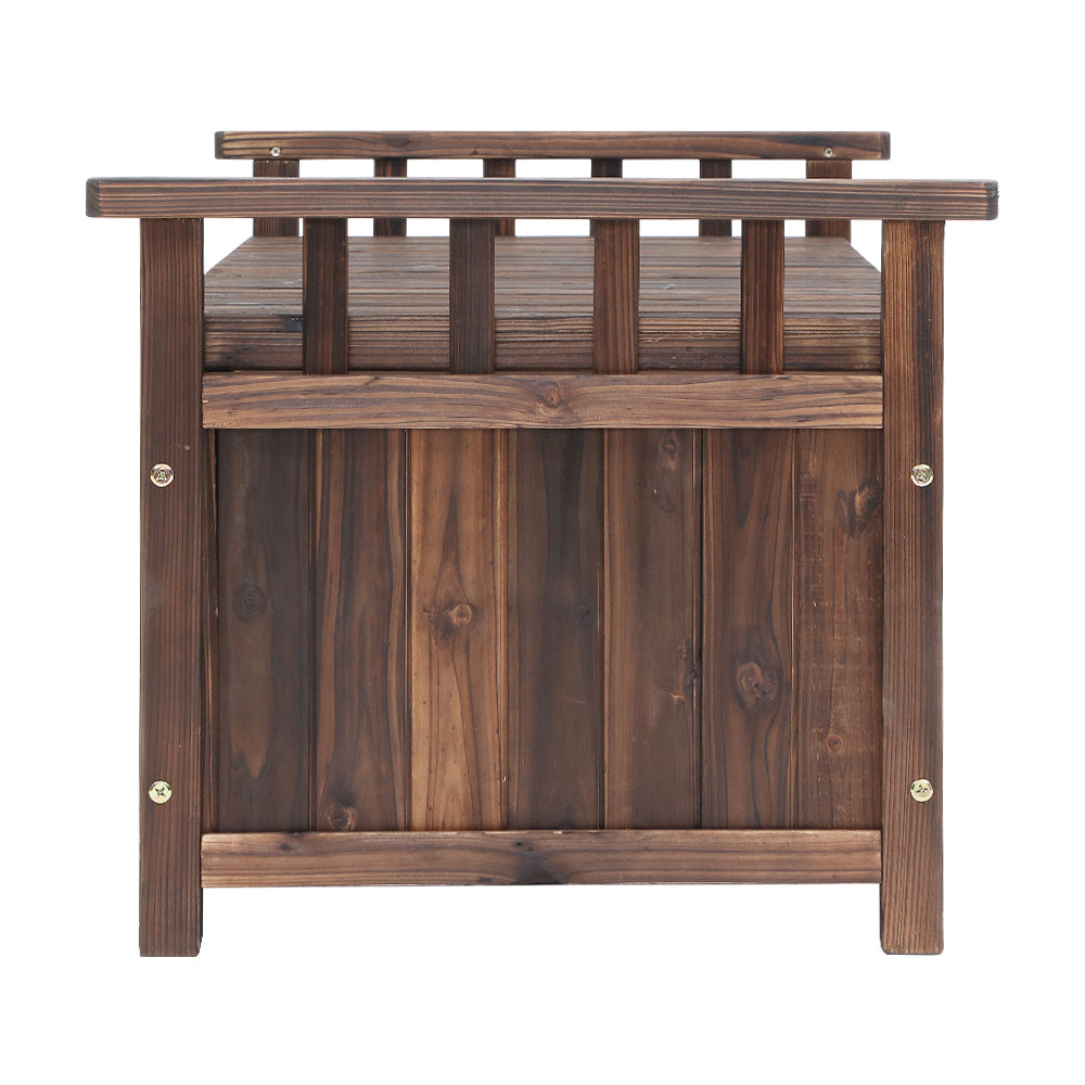 Dark timber storage bench viewed from end, slatted back rail visible, vertical plank body and feet, white background