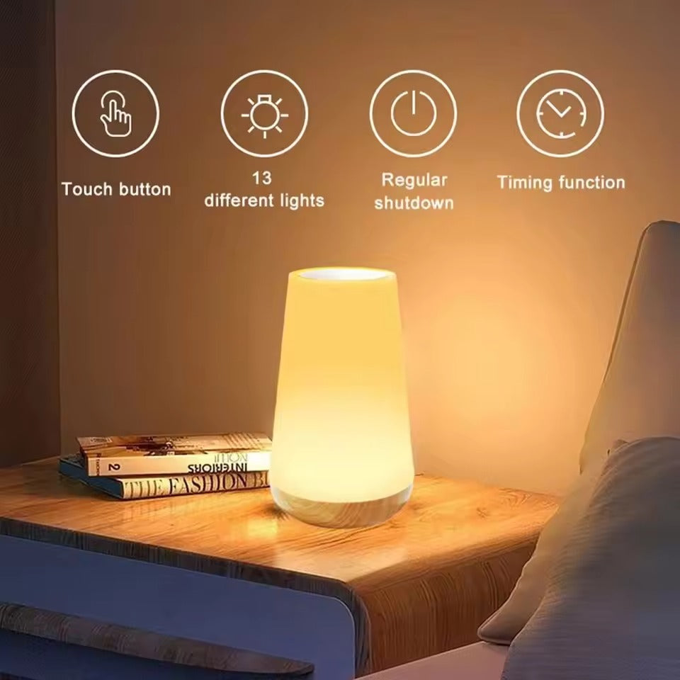 Conical white LED lamp with wood-grain base glowing warm, hand on top; RGB remote with colour buttons, timers and ON/OFF