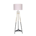 Tripod floor lamp with three black and gold legs and large white cylindrical drum shade on white background