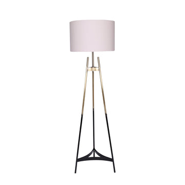 Tripod floor lamp with three black and gold legs and large white cylindrical drum shade on white background