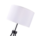 Angled close-up of white fabric drum shade and pull-chain on tripod floor lamp, tripod legs visible below