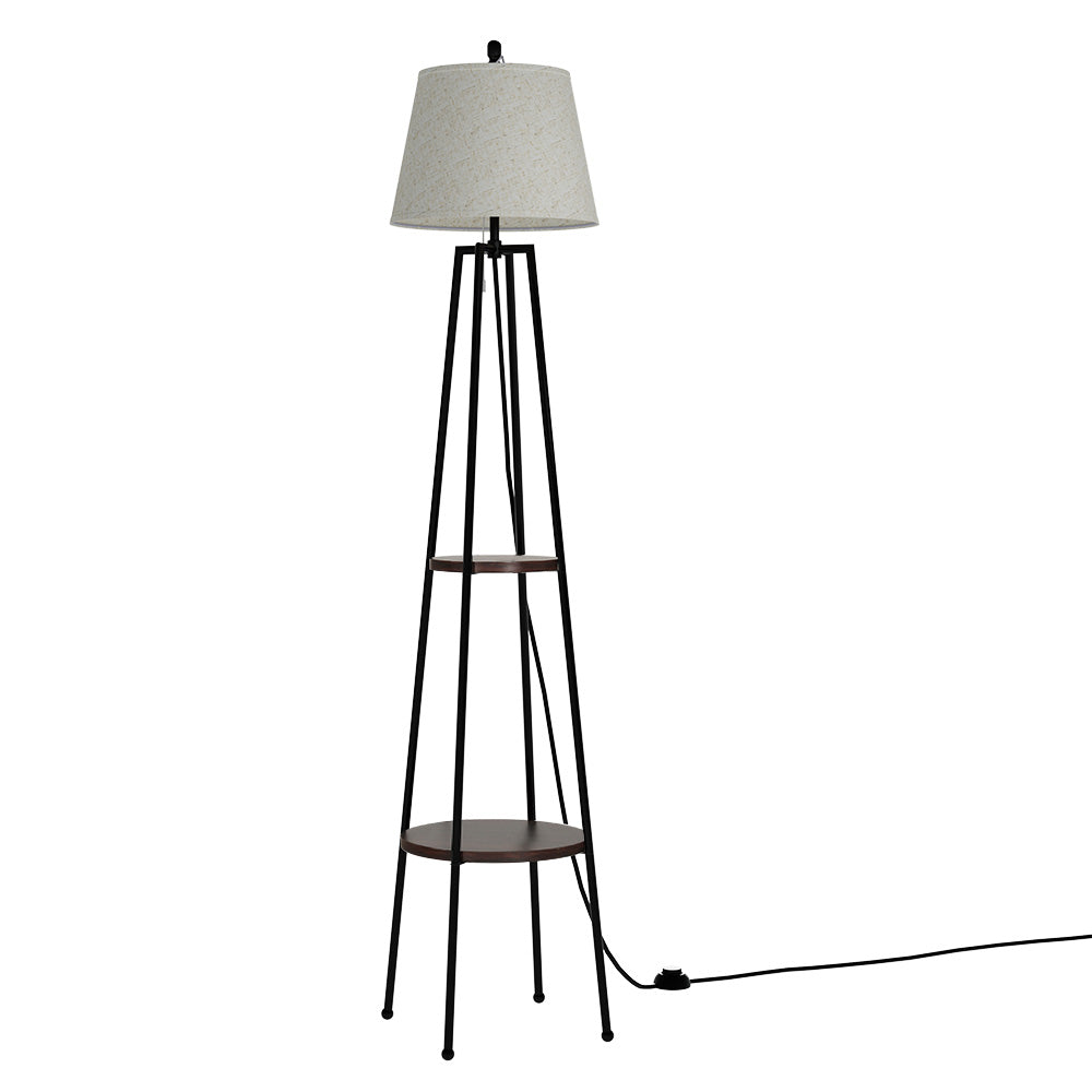 Black tripod floor lamp with two round walnut shelves and grey fabric drum shade on white background, front view
