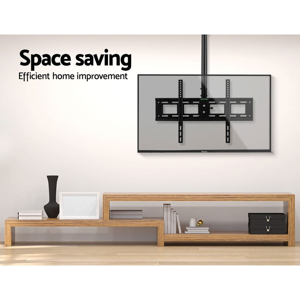 TV ceiling mount space saving lifestyle with transparent TV mounted from ceiling above oak TV unit in beige room