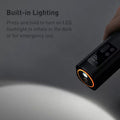 Built-in Lighting: hand holding tyre inflator in dark, LED flashlight on at tip; text: Press and hold to inflate in the dark