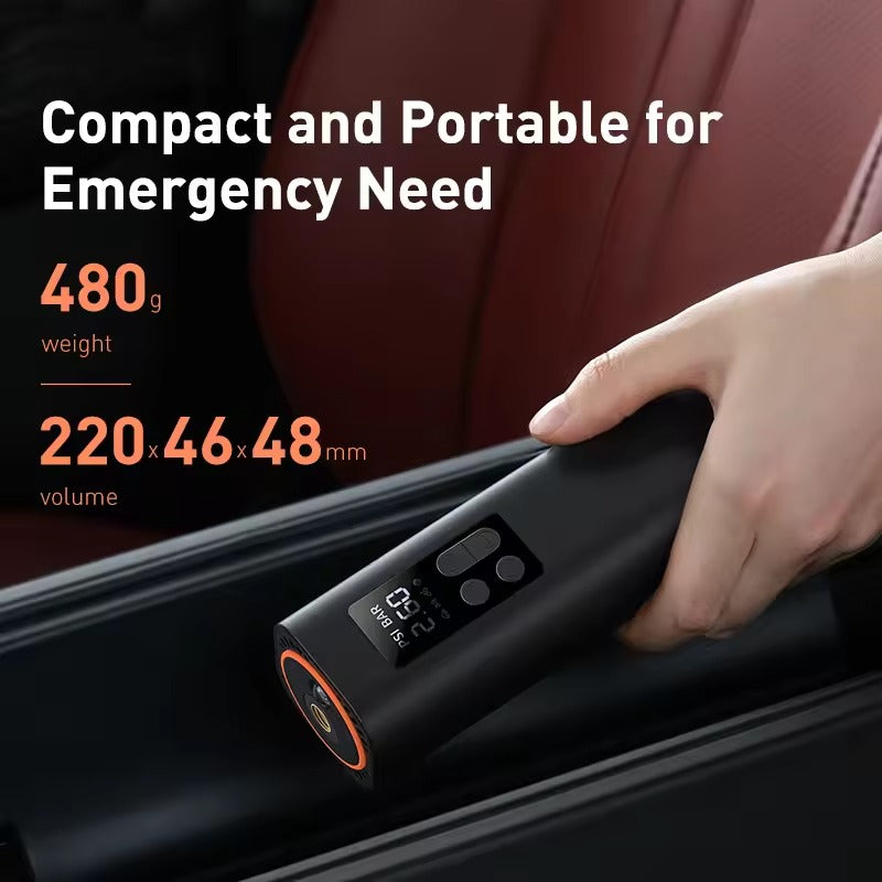 Baseus portable tyre inflator connected to car tyre on asphalt, LCD display showing PSI BAR 2.60, orange cap, control buttons