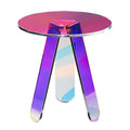 Round iridescent acrylic side table with three flat legs shifting pink, purple and blue on a white background